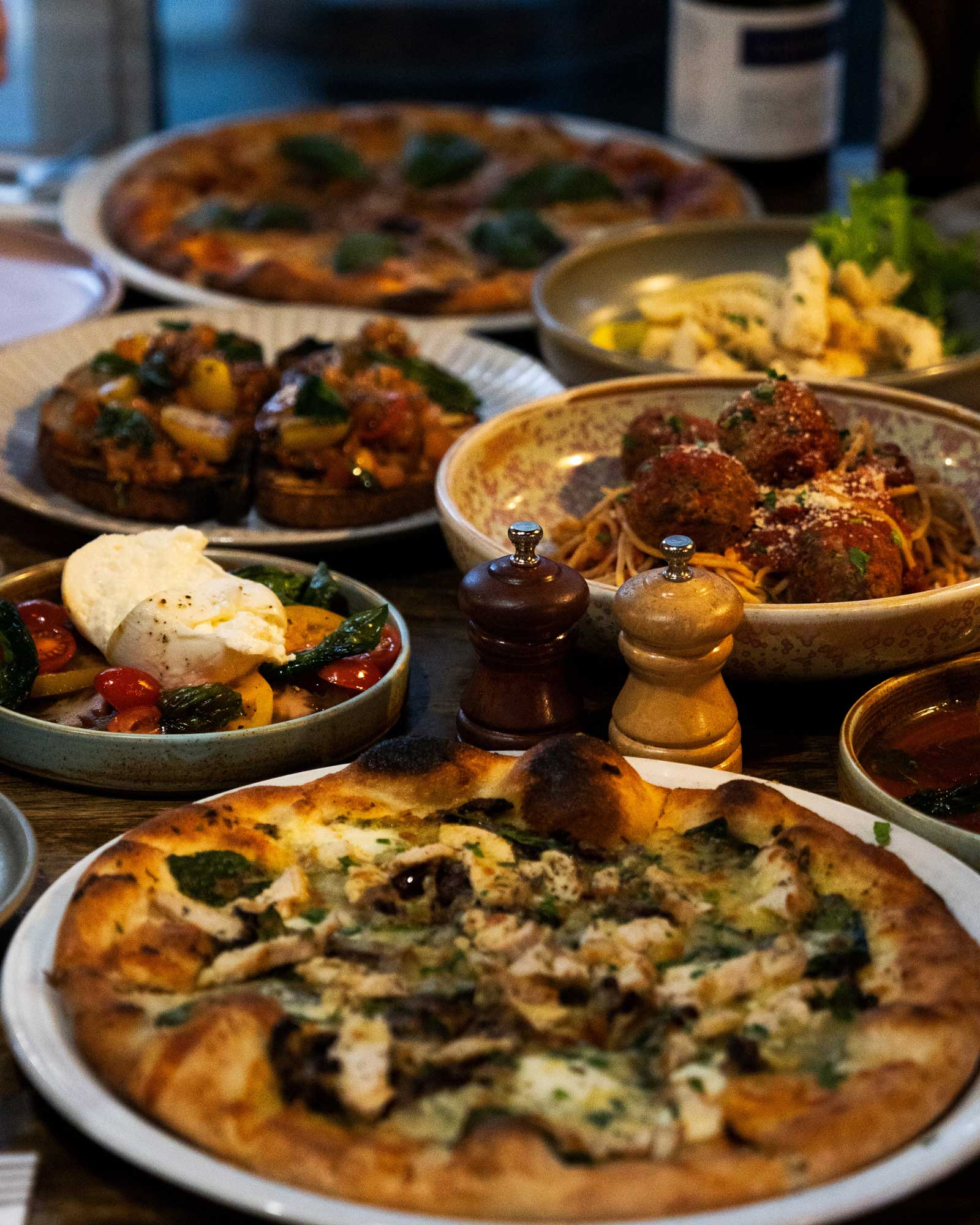 Italian meals on a table at Tins & Wood